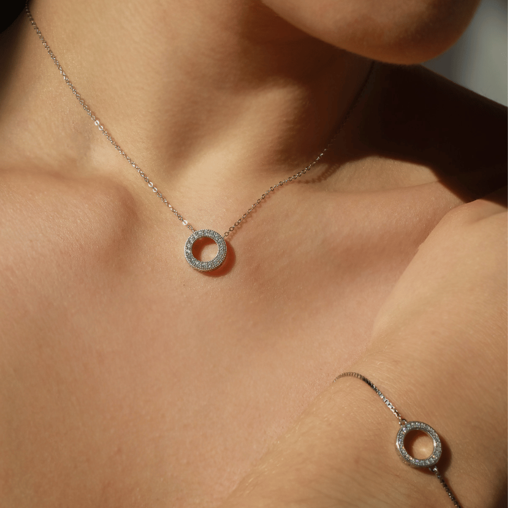 A small circle necklace encrusted with shimmering cubic zirconia stones.
