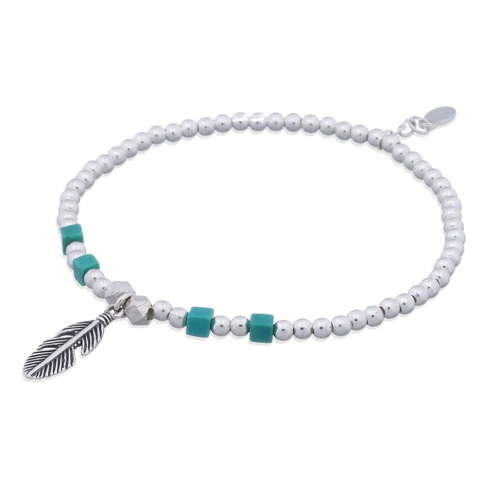 Sterling Silver beads and four square turquoise beads on a stretch bracelet with a high polish finish.