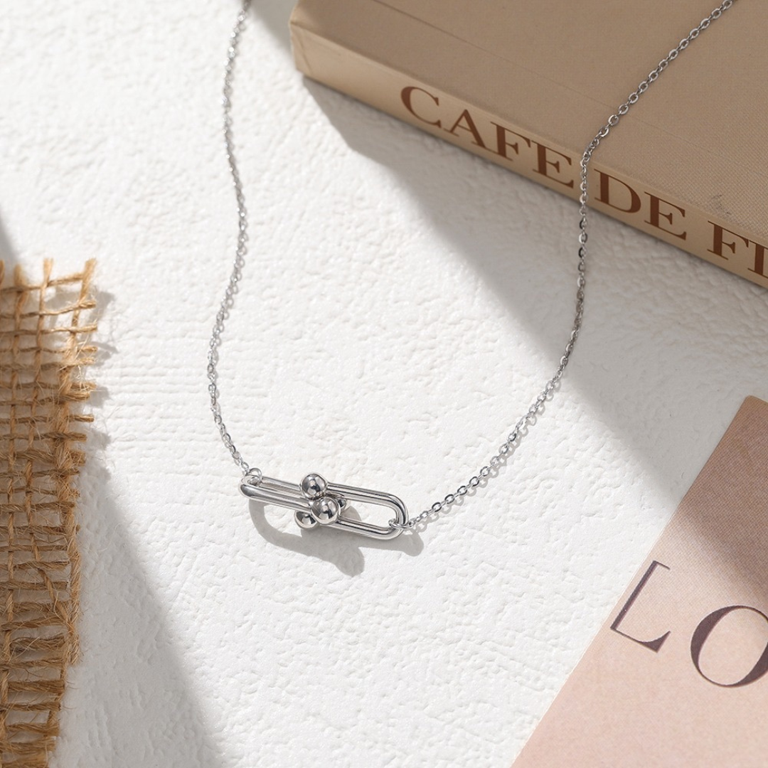 Sterling Silver Link Pendant Necklace styled in a lifestyle setting, showing its modern, minimalist elegance