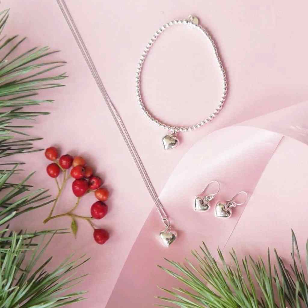 Matching puffed heart bracelet, necklace and earrings.