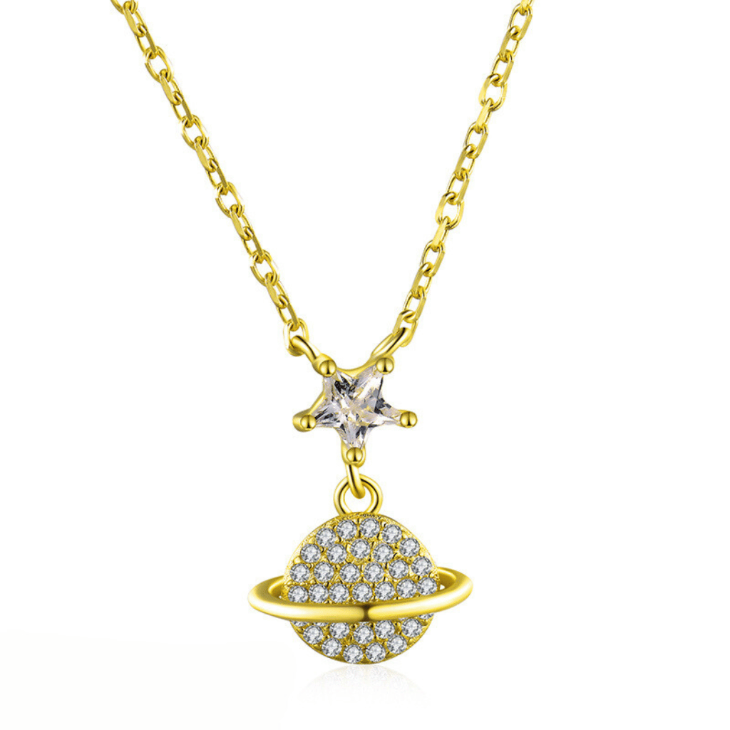 A gold necklace with a tiny star featuring a small orbit encrusted in cubic zirconia stones on a gold chain.