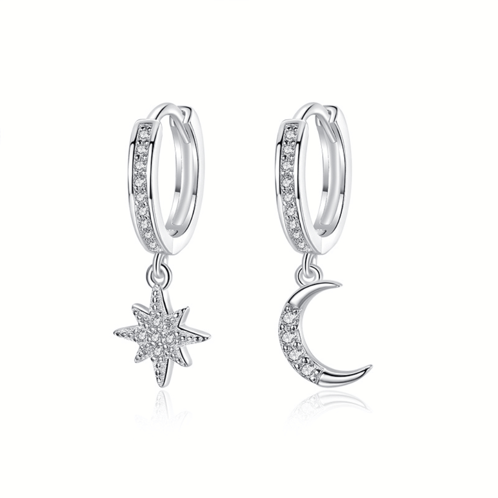 A pair of huggie Moon and Star earrings encrusted in cubic zirconia stones.