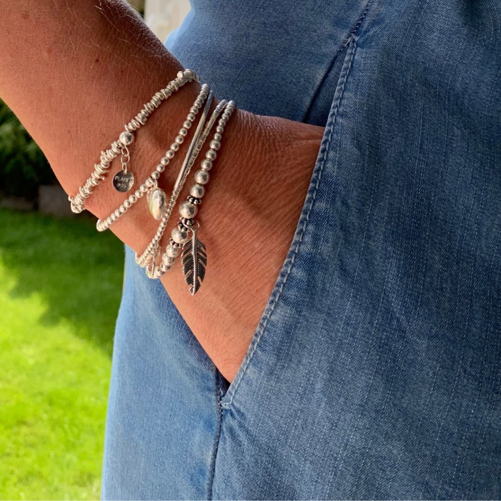 A solid silver stretch bracelet with a high polish finish.