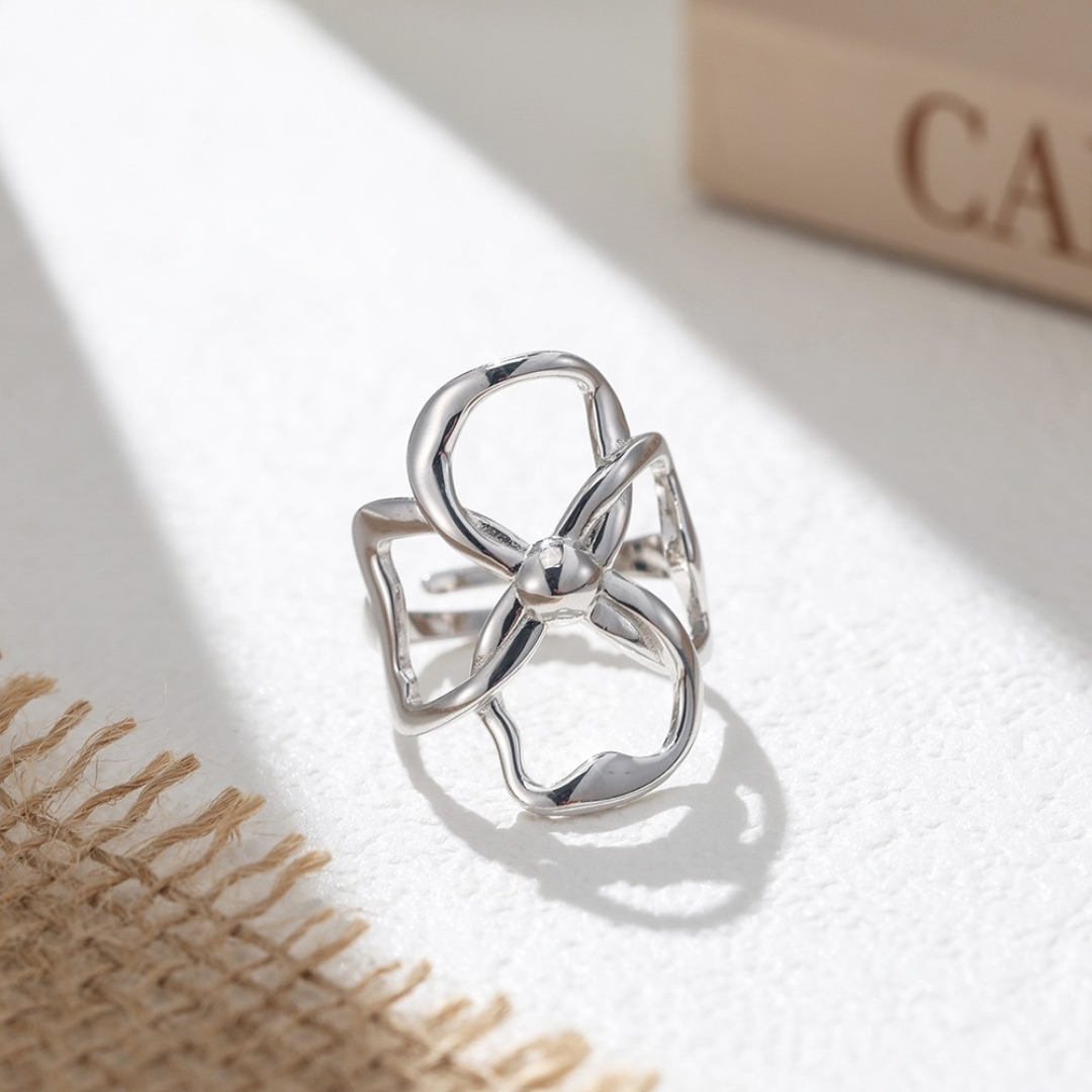 Sterling Silver Abstract Bloom Ring displayed in a styled close-up, highlighting its sculptural open-petal design and polished finish