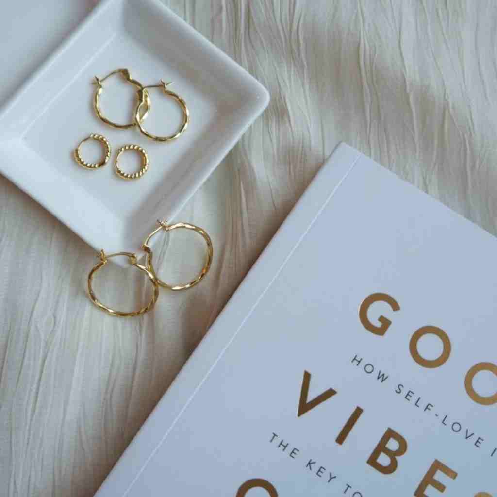 Minimal style gold hoop earrings crafted from sterling silver with gold plate.