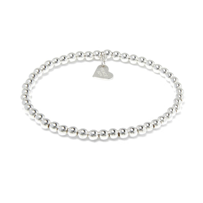 Sterling Silver bracelet with continuous 4mm balls         featuring a flat heart charm. A timeless bead bracelet with high polish finish.