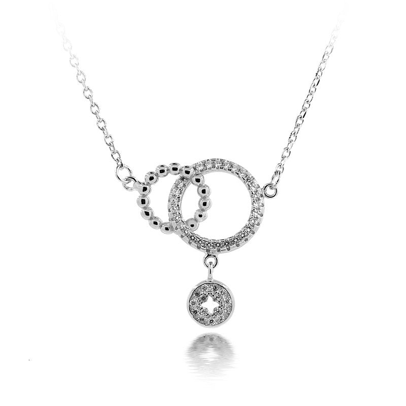 A sparking necklace with two circles overlapping on a chain.