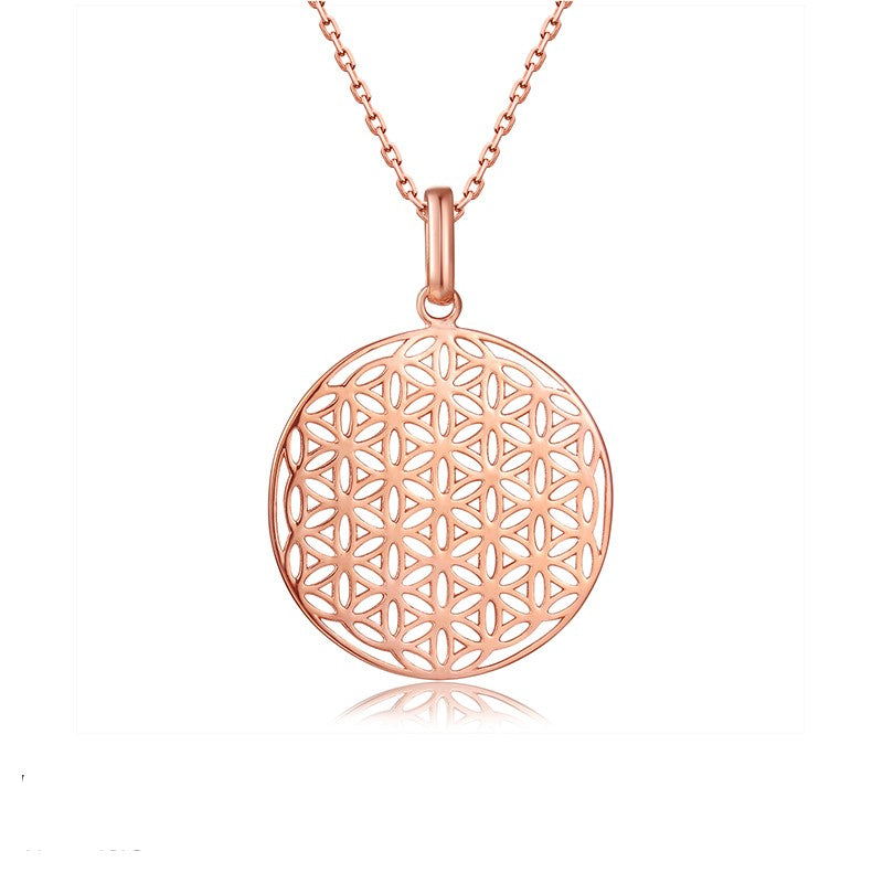 High polished finish circle charm on a rose-gold adjustable chain. The charm circle has intricate detail flower pattern in the middle.