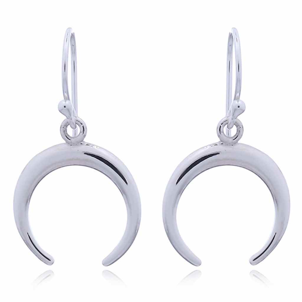 Silver earrings shaped as crescent moons on a french hook.