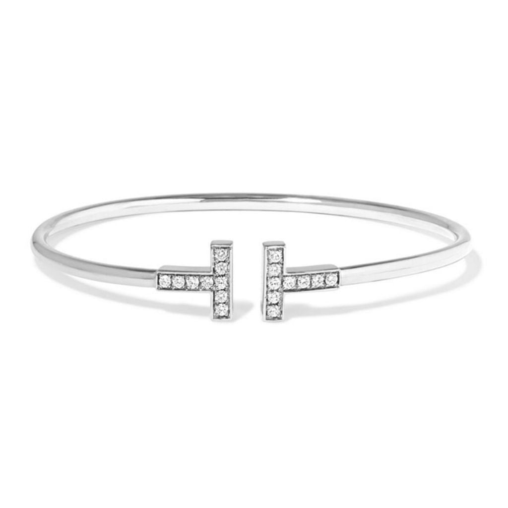 A sophisticated sterling silver bangle with two T shape ends that are encrusted with sparkling cubic zirconia stones.