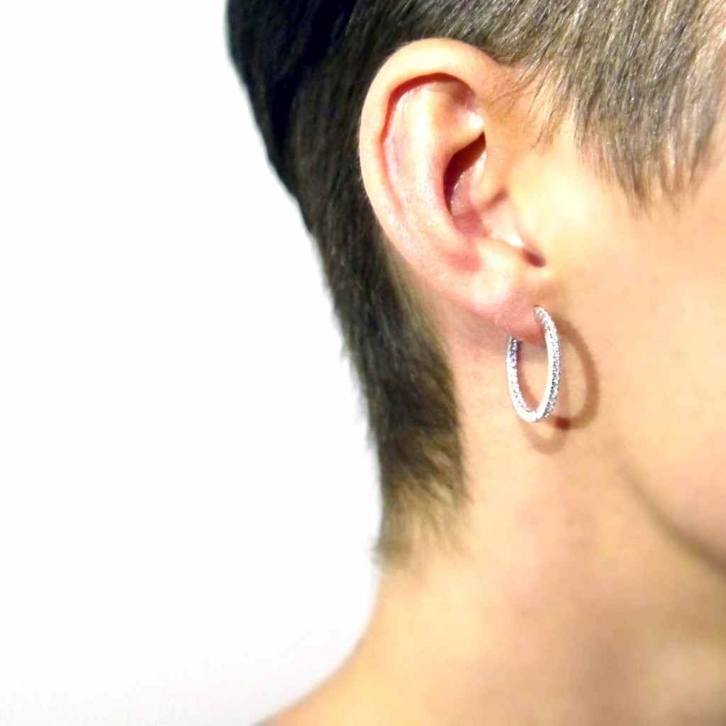 Shimmering Sterling Silver Hoop earrings  encrusted in cubic zirconia stones.